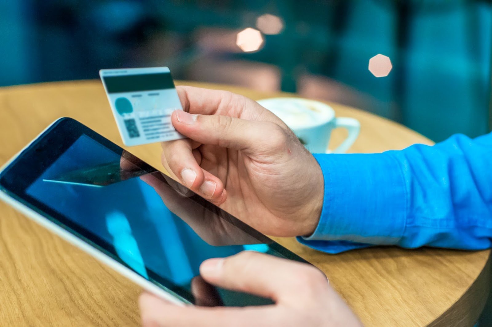 Close up of man using credit card and phone